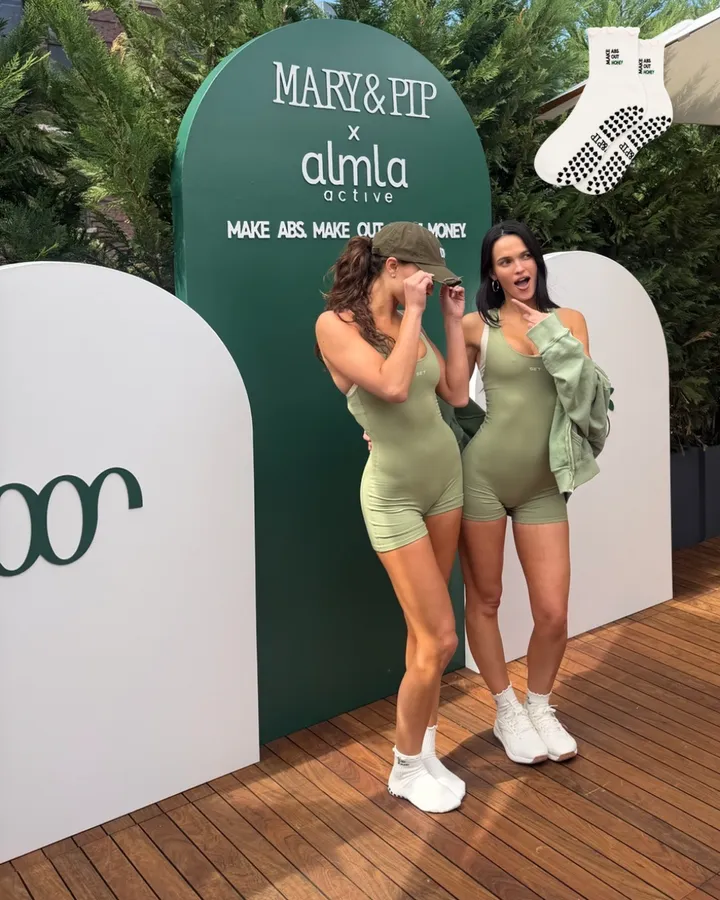 Two friends at the Mary & Pip x Almla event in matching green sets and Make Money grip socks