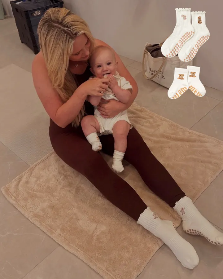 A mother and baby on a mat in matching Mama Bear and Baby Bear grip socks